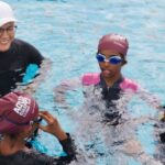 Swimin12 coach teaching young children to learn to swim